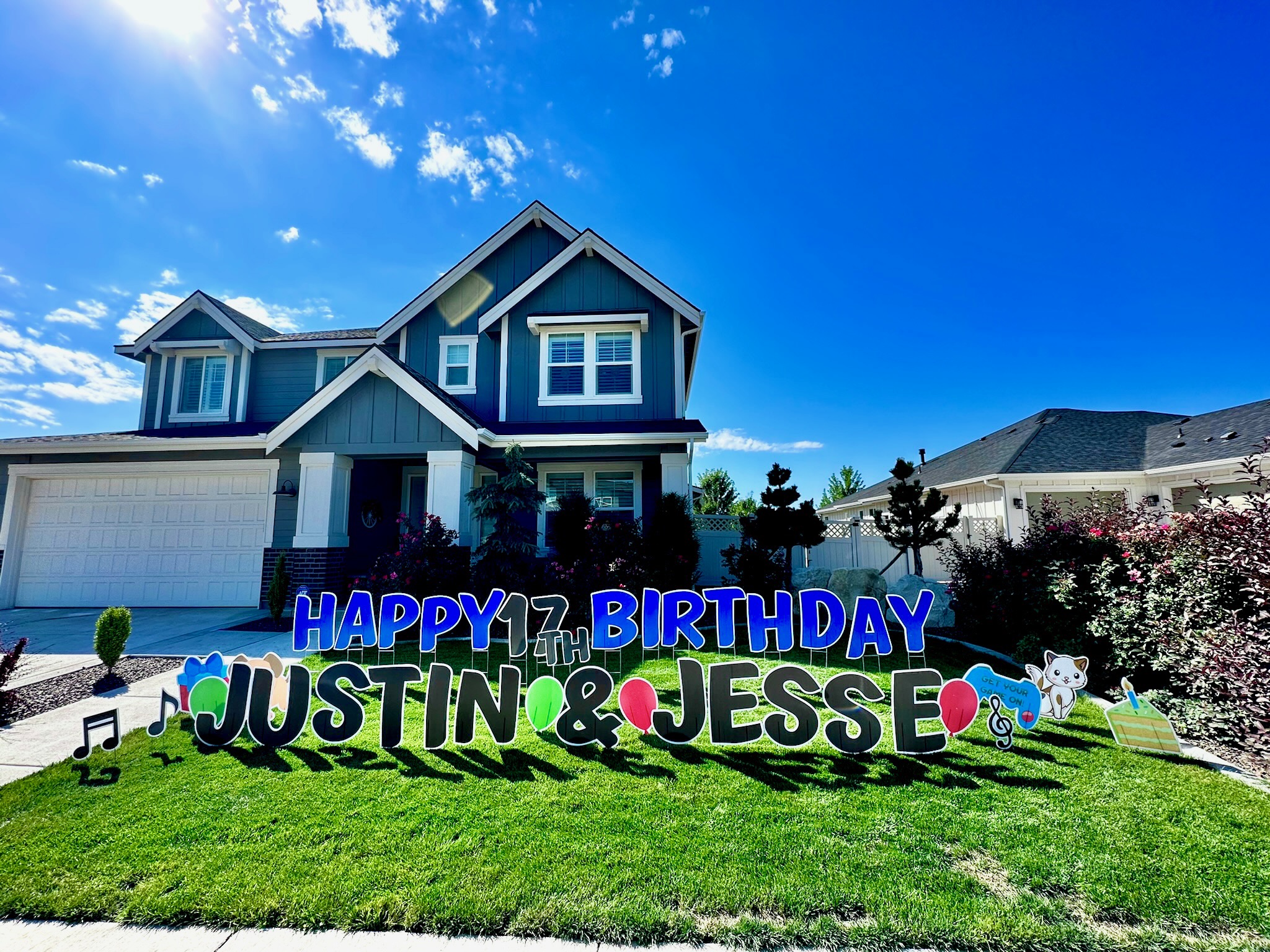 Happy Birthday Justin and Jesse double name yard card display with colorful letters and art in Boise Idaho