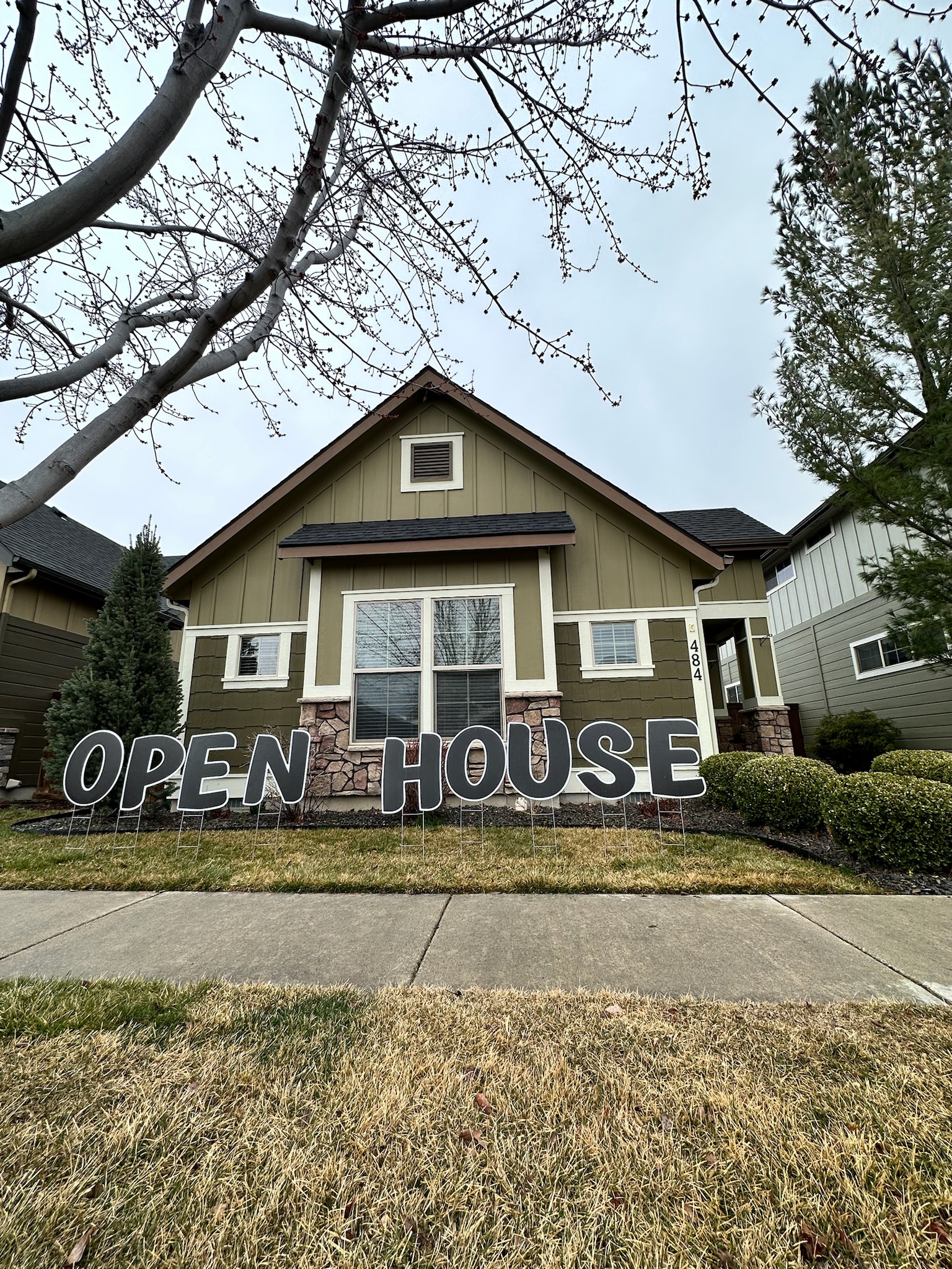 Open House yard card display with white letters and real estate signage in Boise Idaho