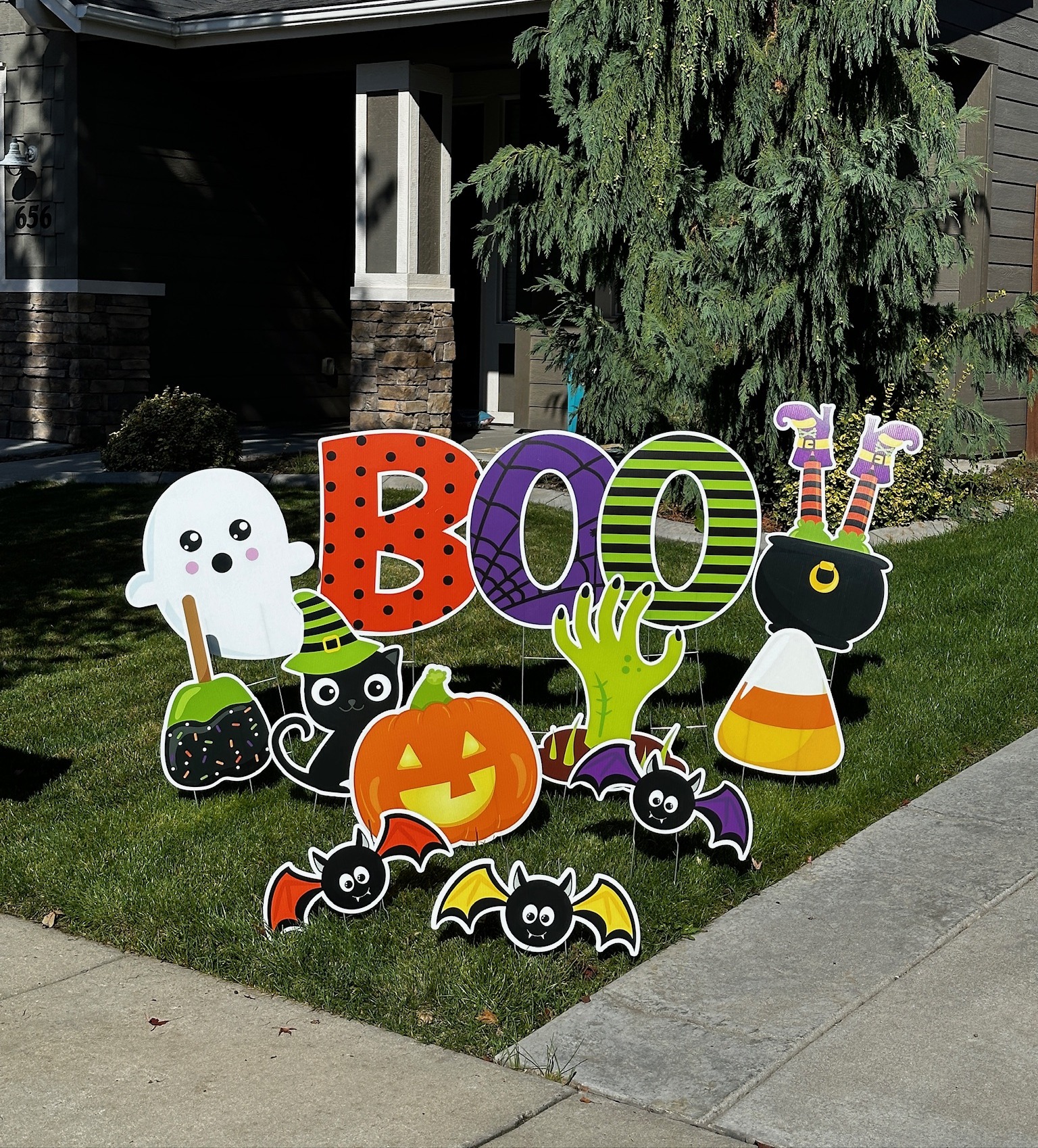Halloween BOO yard card display with ghost pumpkin candy corn and spooky art in a Boise Idaho front yard