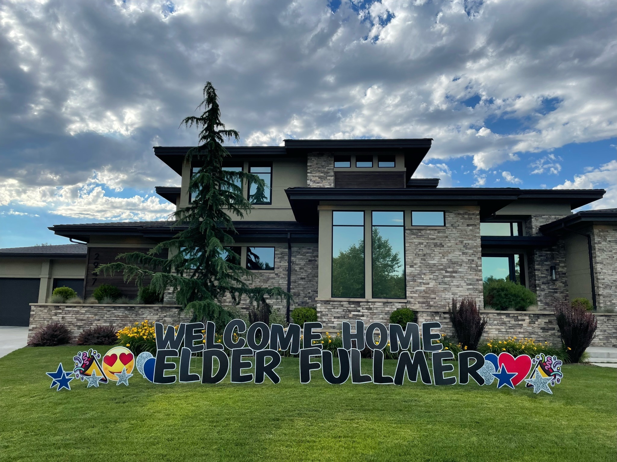 Welcome Home Elder Fullmer missionary homecoming yard card display with large letters in front of a stunning Boise Idaho home
